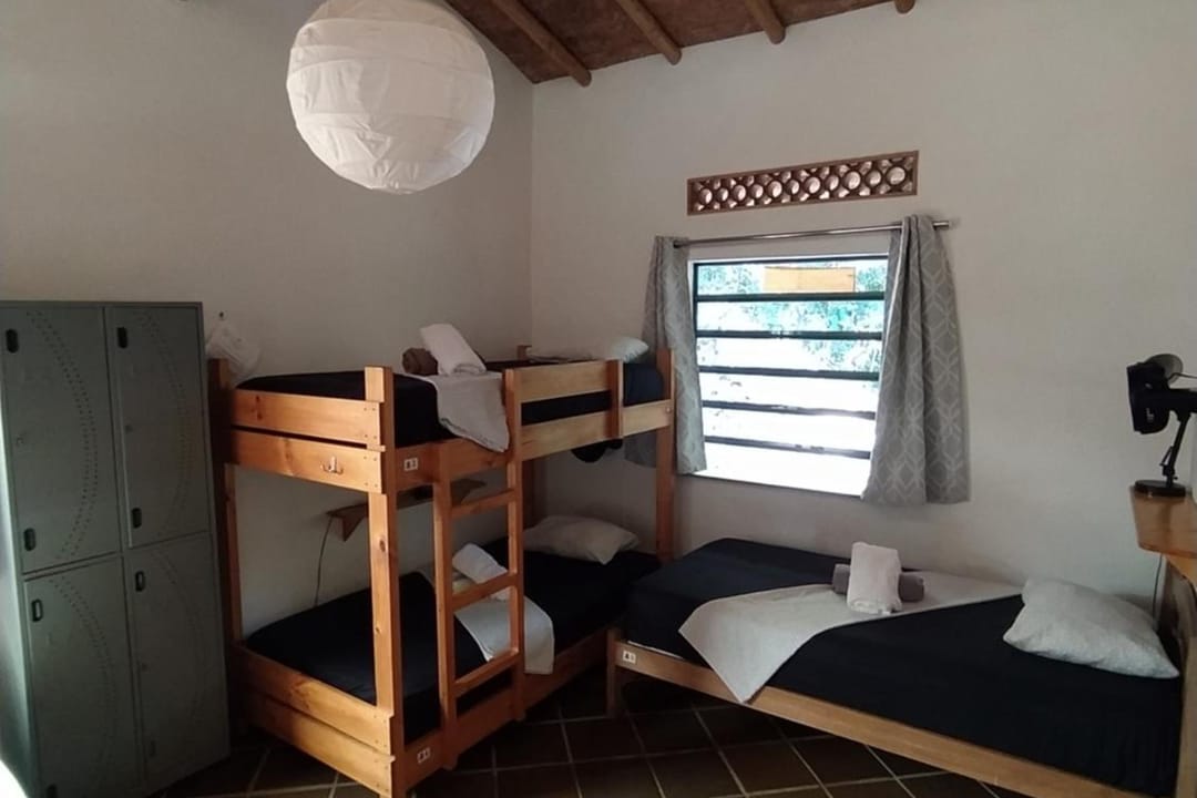 Camarote, lockers grises y lámpara de papel en el dormitorio.